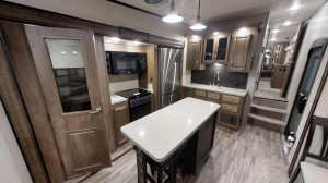 The large island kitchen gives you the space to cook and the rear den gives you space to entertain in the Coachmen Chaparral 381RD at Byerly RV