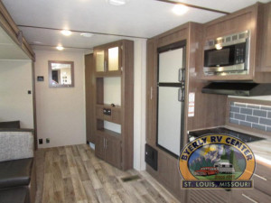 The Keystone Hideout 338LHS travel trailer is loaded with queen bedroom, bunk room with half bath, and more.